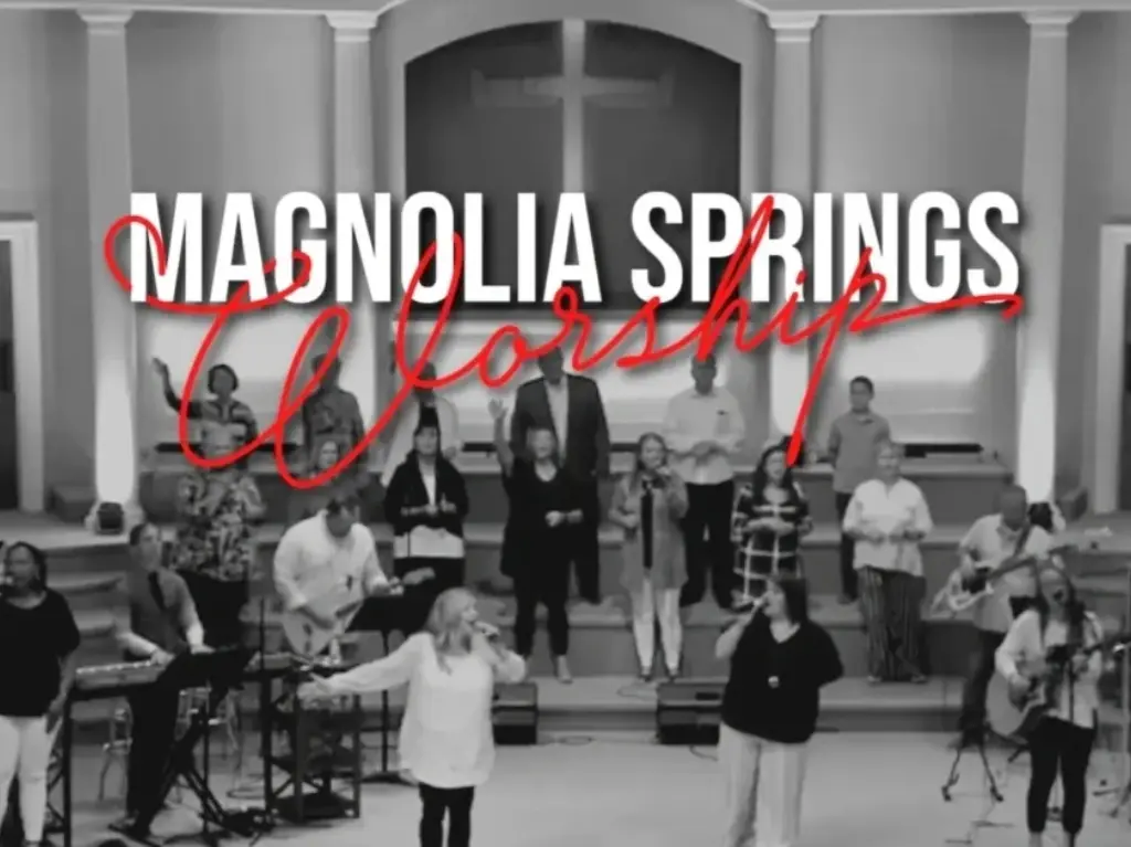 MAGNOLIA banner with people singing in the background